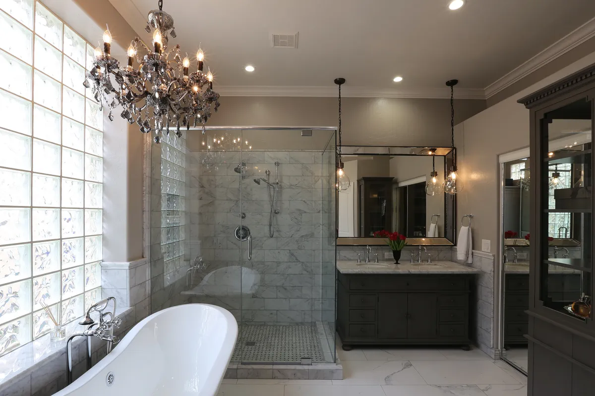 luxury bathroom with chandalier and marble newly remodeled by bathroom remodelr in saint augstine, fl