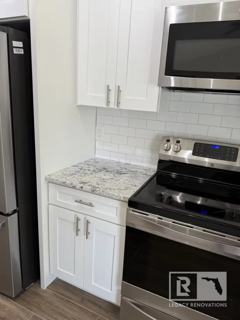Stainless steel stove and microwave combination built into white cabinetry, showcasing a modern yet functional design.