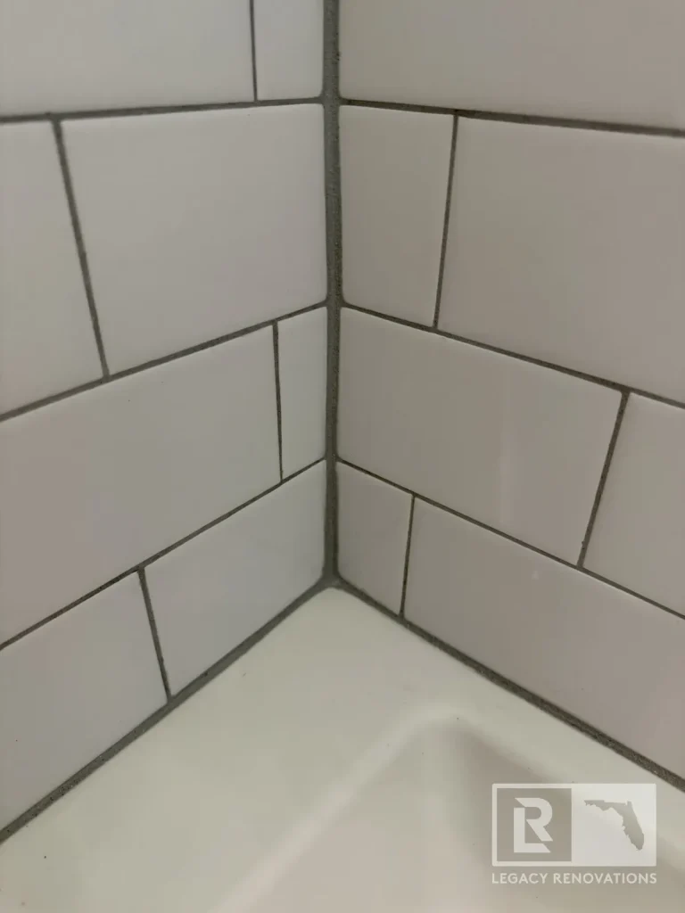 Close-up of white rectangular shower tiles meeting at a corner in Jacksonville, FL