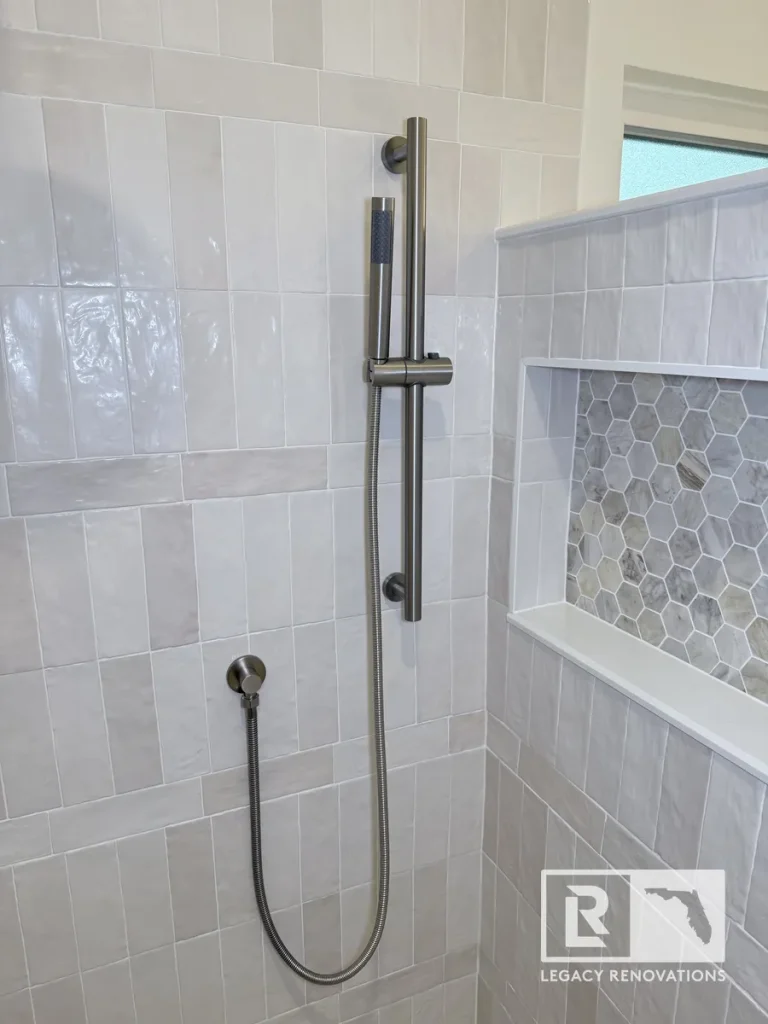 Vertical slide rail holding a cylindrical shower wand connected to a flexible hose in a Mandarin Jacksonville FL home.